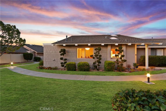 Front view of a single-story house with a landscaped garden.