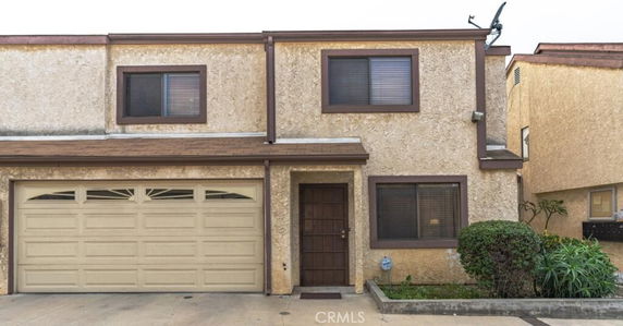 Front view of a two-story house with an attached garage.