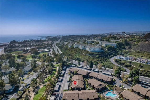 Panoramic view of a coastal area with residential buildings and a distant ocean.