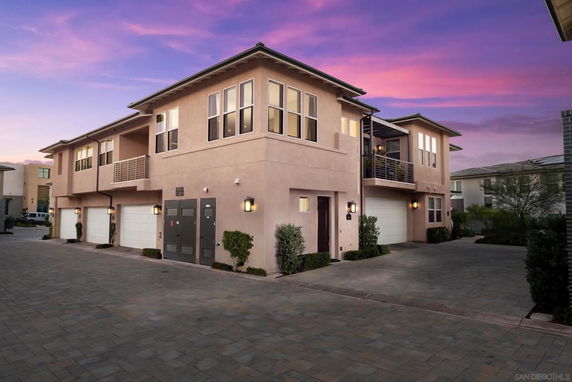 Front view of a two-story house with multiple garage doors.