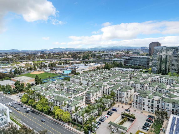 Panoramic view of a residential area with multiple buildings and roads extending into the distance.