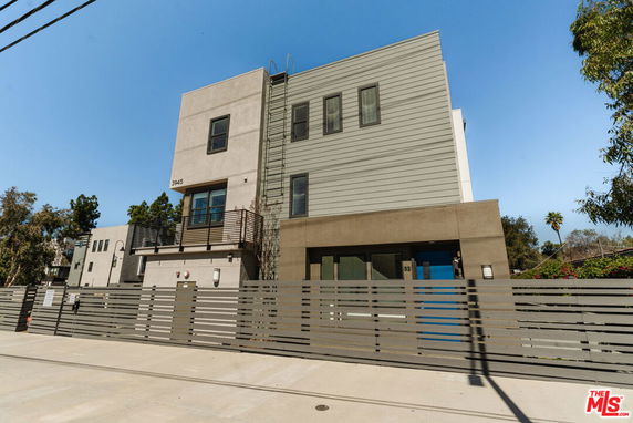 Front view of a modern multi-story house with a minimalist design.