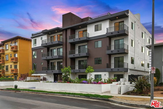 Front view of a modern multi-story apartment building.