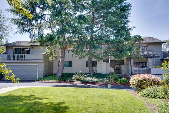 Front view of a two-story house with balconies and a double garage.