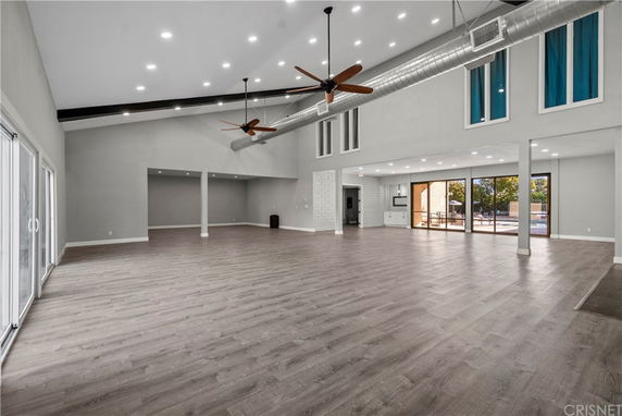 Spacious indoor area with high ceilings and ceiling fans.