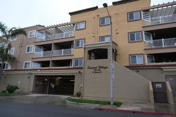 Front view of a multi-story residential building with balconies.