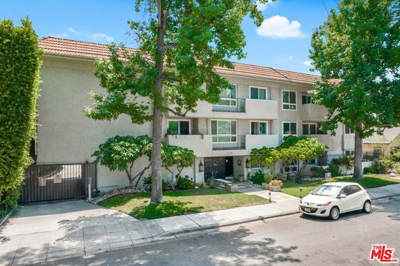 Front view of a multi-story residential building with balconies.