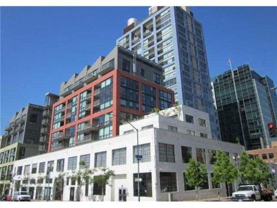 Front view of a multi-story residential and commercial building.