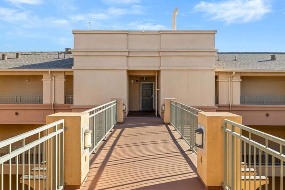 Front view of a building with a walkway leading to an entrance.
