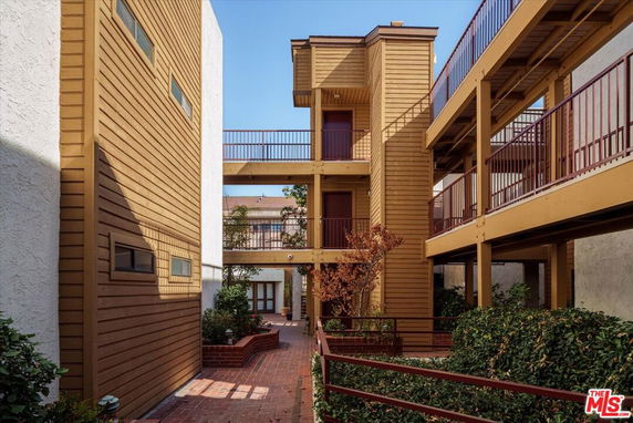 View of a multi-story building with wooden siding and balconies.