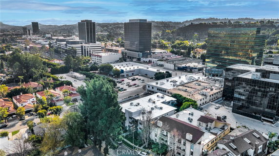 Panoramic view of a cityscape with multiple buildings and trees.