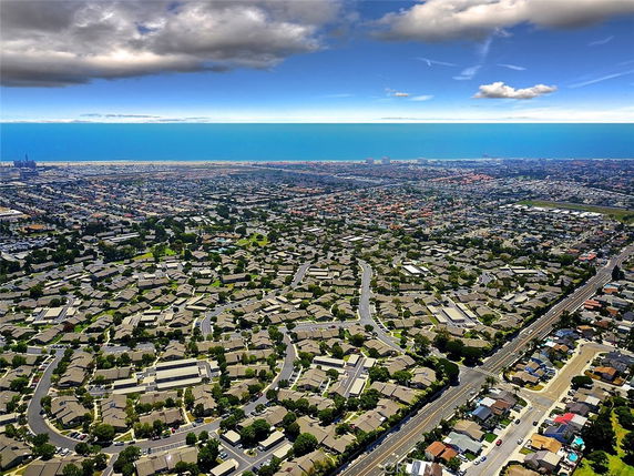 Aerial panoramic view of a suburban area with numerous houses and streets.