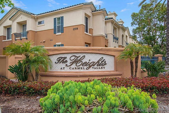 Front view of a multi-story residential building with a sign reading 'The Heights at Carmel Valley'.