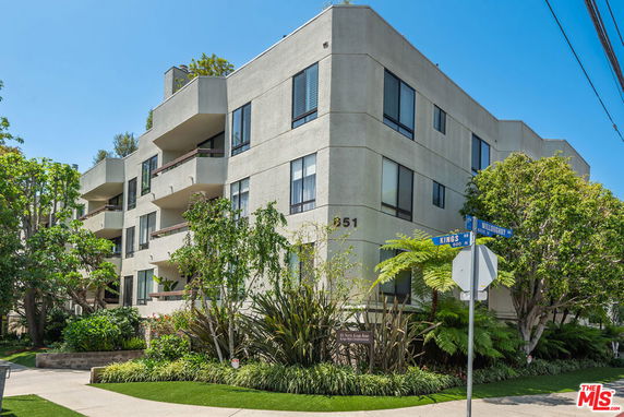 Front view of a multi-story apartment building with balconies.