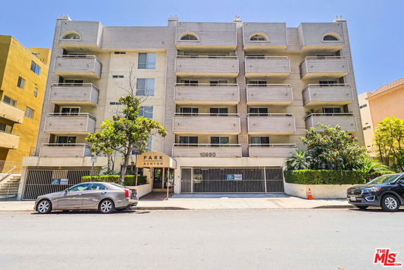Front view of a multi-story apartment building with balconies.