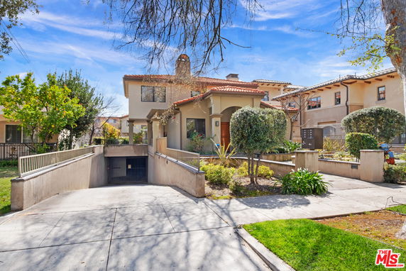 Front view of a two-story house with an attached garage entrance.