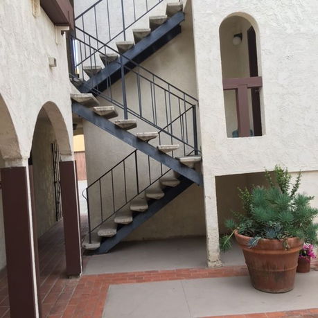 Side view of a building with an exterior staircase.