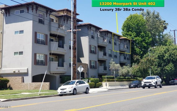 Front view of a multi-story residential building with balconies.
