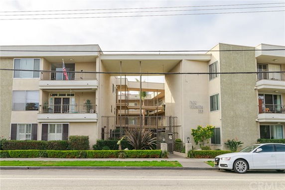 Front view of a multi-story residential building with balconies.