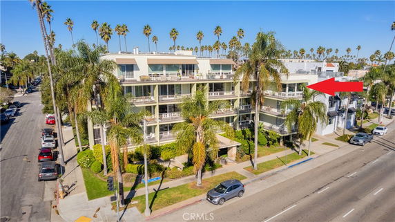 Front view of a multi-story residential building with balconies.