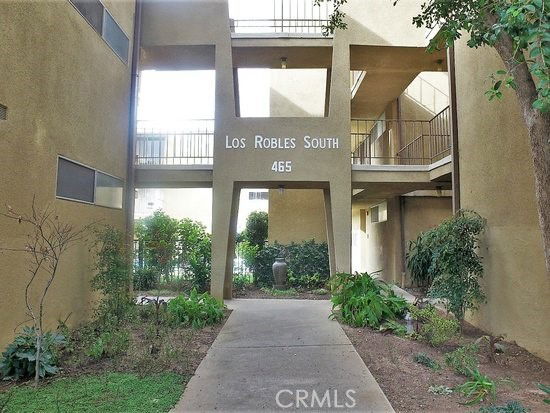Front view of a building named Los Robles South with entrance and balconies.