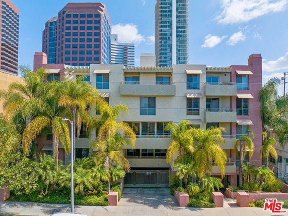 Front view of a multistory residential building with balconies.