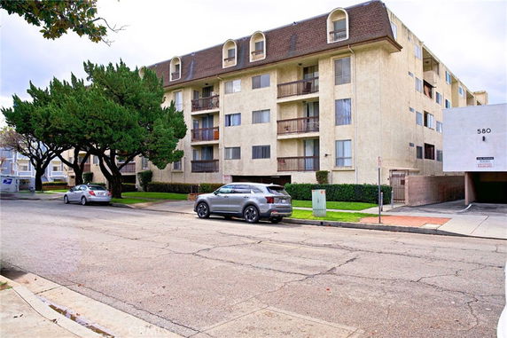 Front view of a multi-story residential building with balconies.