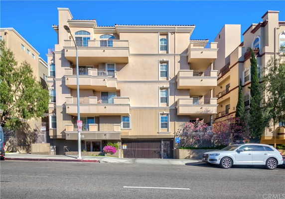 Front view of a multi-story residential building with balconies.