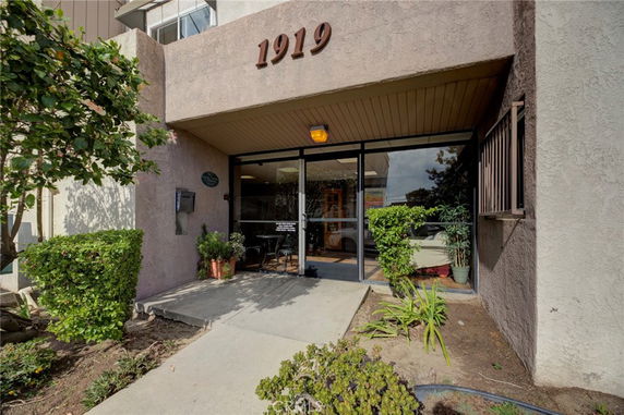 Front entrance of a building with the number 1919 above the door.