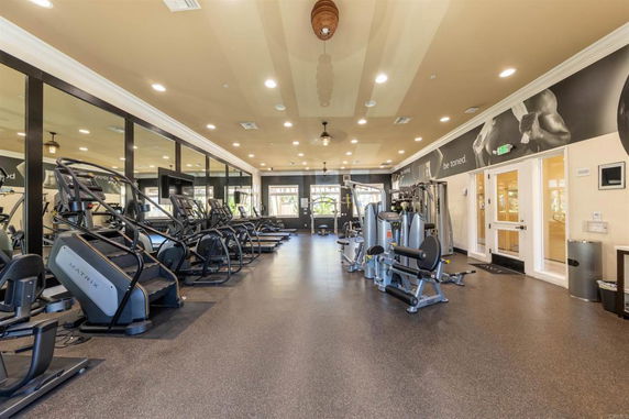 Interior view of a gym with exercise machines and equipment.