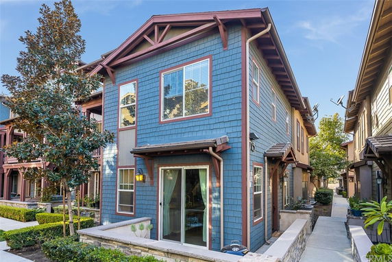 Front view of a two-story house with blue siding and brown trim.
