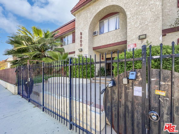 Front view of a building with a gated entrance.