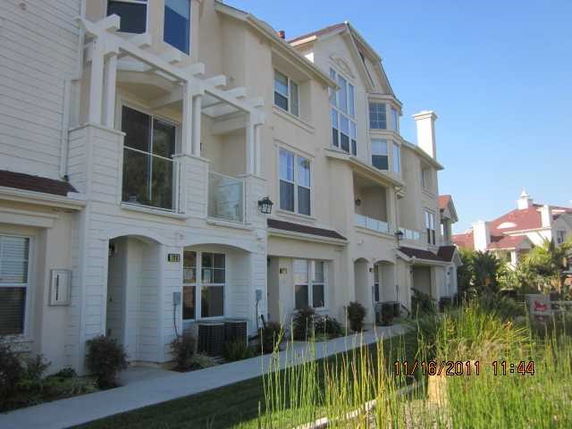Front view of a multi-story residential building with balconies.