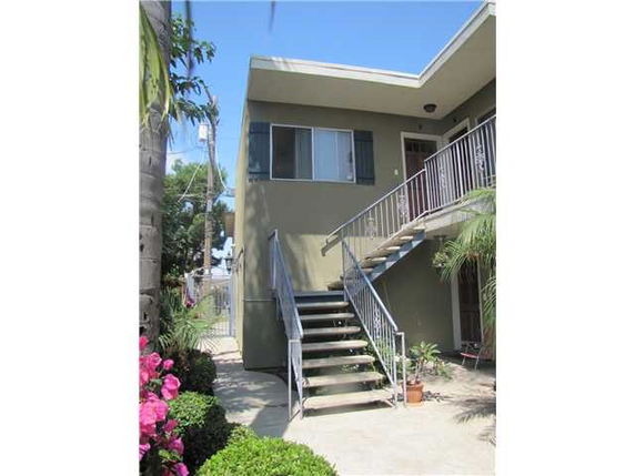 Front view of a two-story building with an external staircase.
