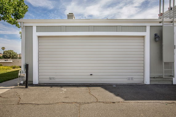 Front view of a single-story building with a closed garage door.