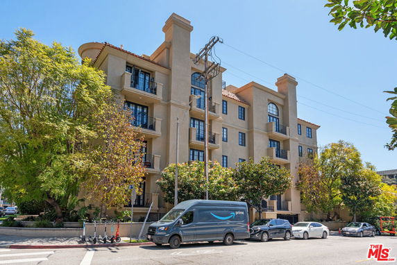 Front view of a multi-story residential building with balconies.