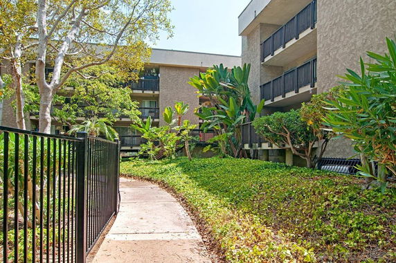 Front view of a multi-story building with balconies.