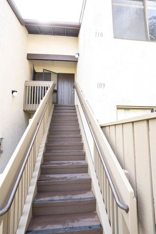 Staircase leading to the entrance of a building with visible unit numbers.