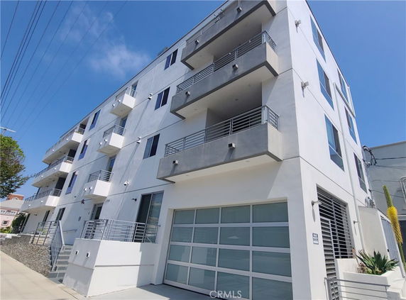 Front view of a multi-story modern apartment building.