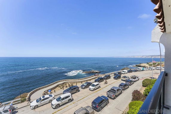 Panoramic view from a building showing a coastal road and ocean.