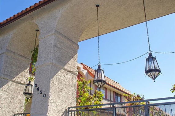 Front view of a house with hanging lanterns and arched entrance.