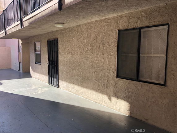 View of a building exterior with textured walls and a metal door.