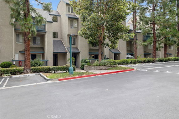 Front view of a multi-story residential building with a grey facade.