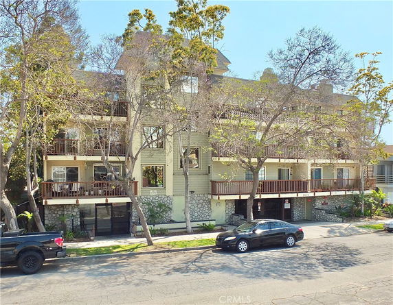 Front view of a multi-story building with balconies and stone accents.