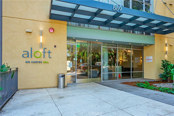 Entrance to a modern building with glass doors and overhead awning.