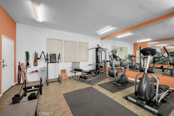 Indoor gym area with exercise equipment and mirrors.