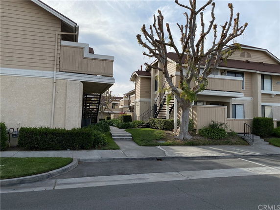 Front view of a multi-story residential building with balconies.