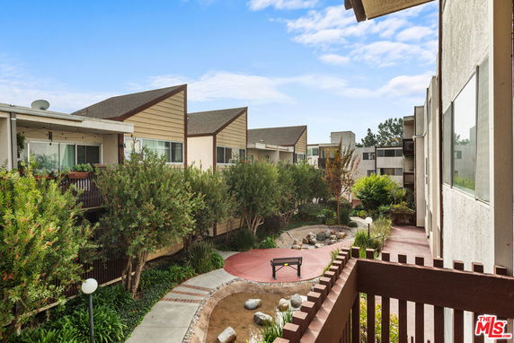 View of apartment complex with landscaped courtyard.