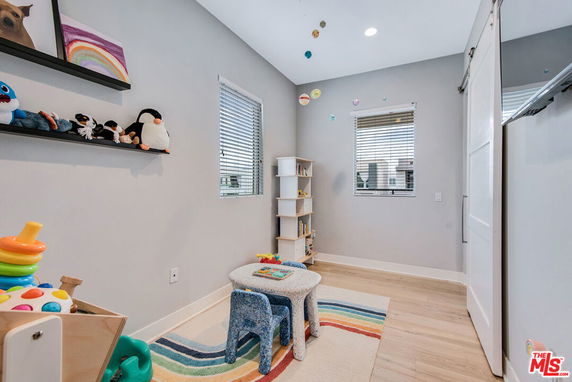 Indoor play area with toys and books in a well-lit room.