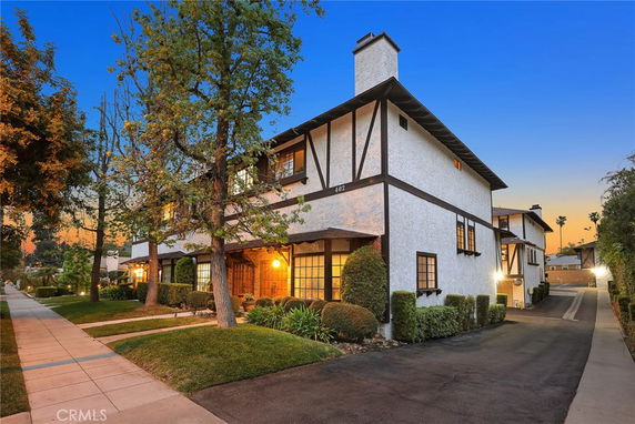 Front view of a two-story house with a chimney.
